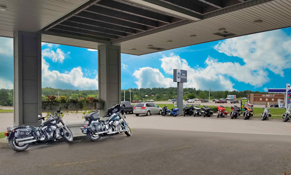 Motorcycles under overhang and in the parking lot