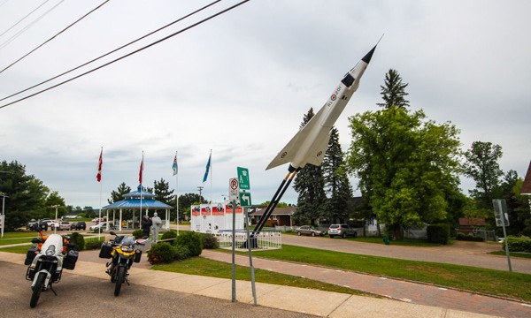 Two motorcycles beside Avro Arrow monument