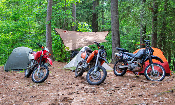 Motorcycles parked with tents