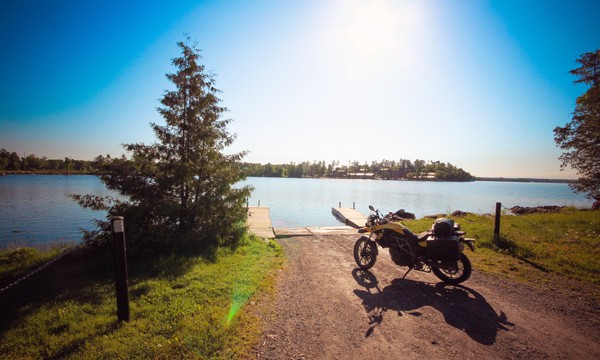 Motorcycle parked by the shoreline of a lake