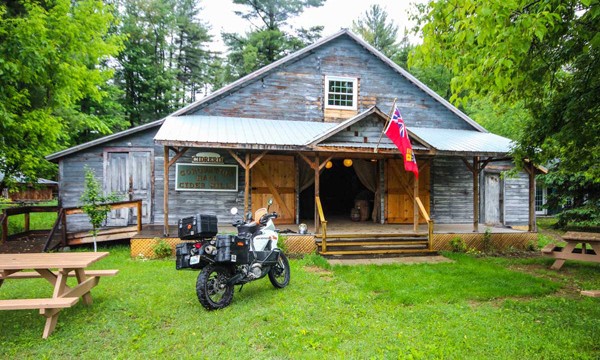 Motorcycle in front of Coronation Hall Cider Mills building