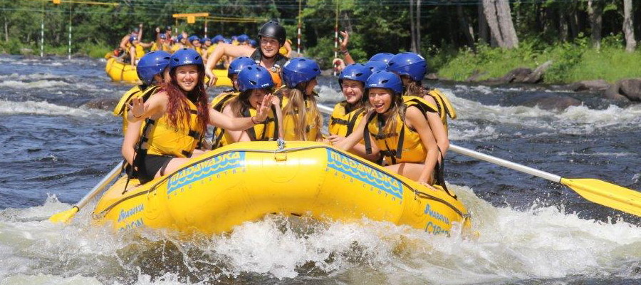 yellow raft on a river with smiling rafters