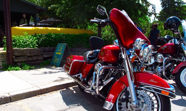  Two motorcycles in front of a yellow canoe