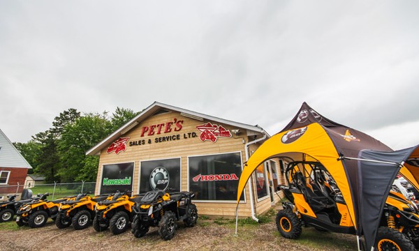  ATVs in front of repair shop