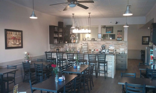 View inside cafe with tables. The bar is in the background.