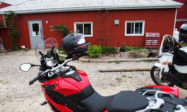 Motorcycles in front of a red building